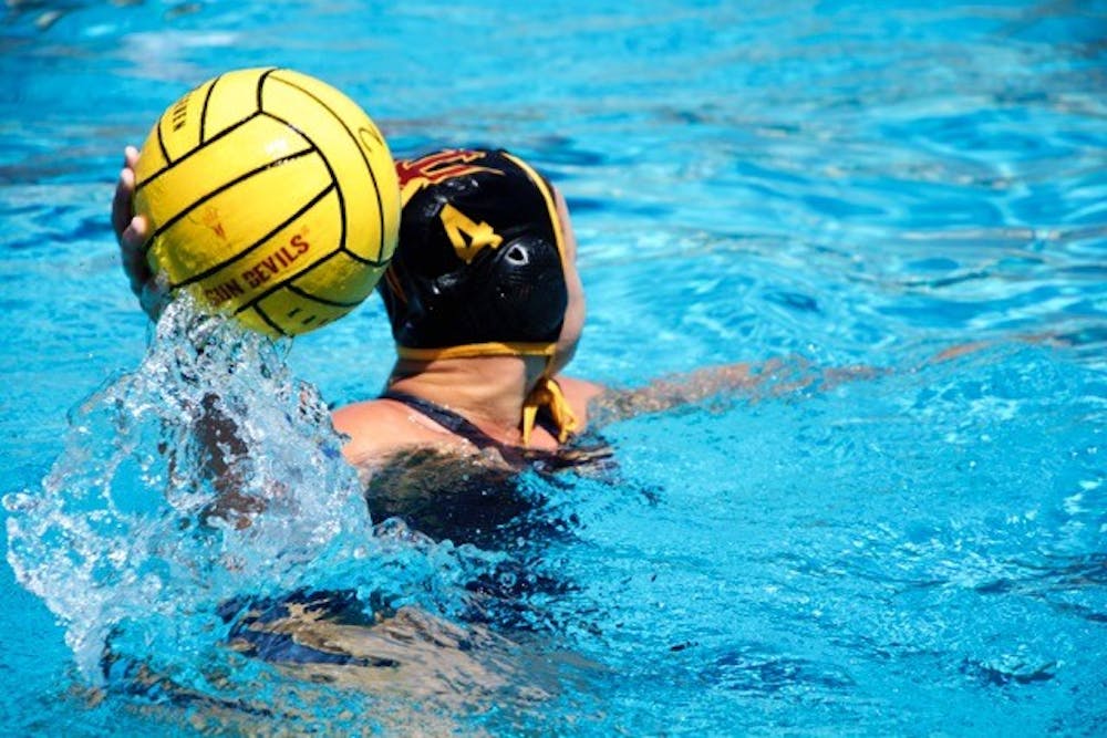 Junior Daisy Carter  passes the ball to a teammate during their game against the Stanford  Cardinals on March 28, 2015, at the Mona Plummer Aquatic Complex.
