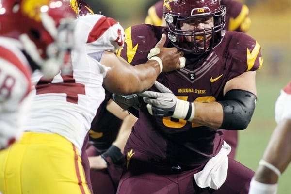STRONG AND SILENT: ASU senior center Garth Gerhart moves left to make a block during the USC game on Saturday. Gerhart’s success as a Sun Devil has come from his quiet work ethic, which serves as an example for the whole team. (Photo by Lisa Bartoli)