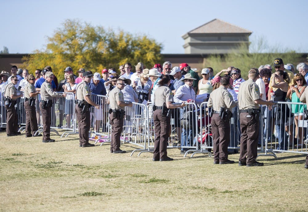 Security personnel patrol a rally for presidential candidate Donald Trump at Fountain Park in Fountain Hills, Arizona, on Saturday, March 19, 2016. 