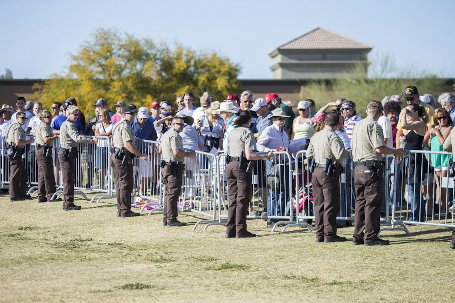 Security personnel patrol a rally for presidential candidate Donald Trump at Fountain Park in Fountain Hills, Arizona, on Saturday, March 19, 2016. 