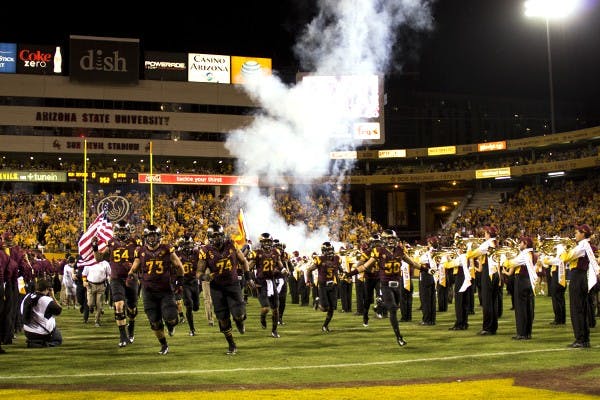 The ASU football team runs out of the Tillman Tunnel at Sun Devil Stadium in a game against Utah on Saturday, Nov. 1, 2014. ASU defeated Utah in overtime 19-16. (Photo by Alexis Macklin)
