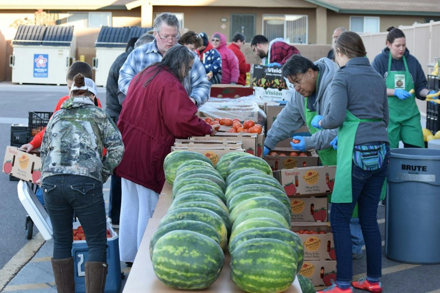 Customers pick out their produce at a Borderlands P.O.W.W.O.W market.&nbsp;