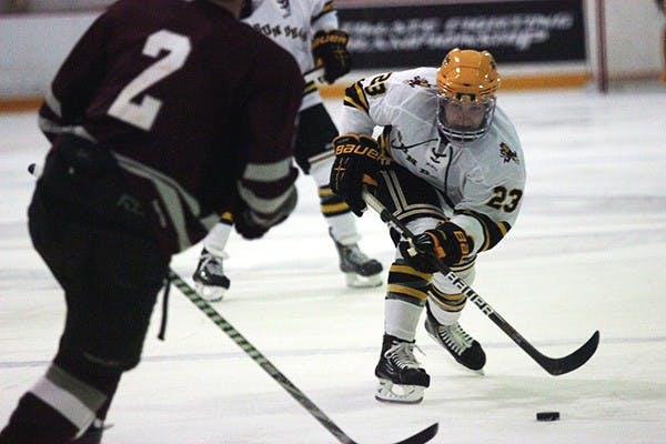 Defender Jordan Young brings the puck up the ice at a home game in Tempe. The hockey team has its first road game against No. 4 Illinois this weekend (Photo by Molly J. Smith)