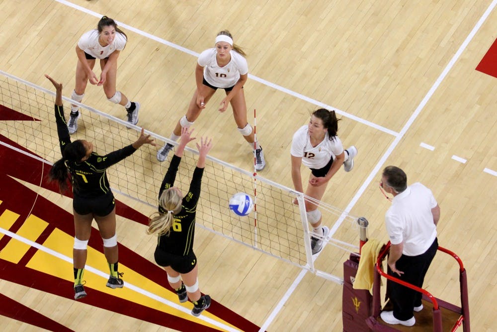 The ASU women's volleyball team sends the ball over the net during the game against Oregon on Oct. 6. (Photo by Diana Lustig)