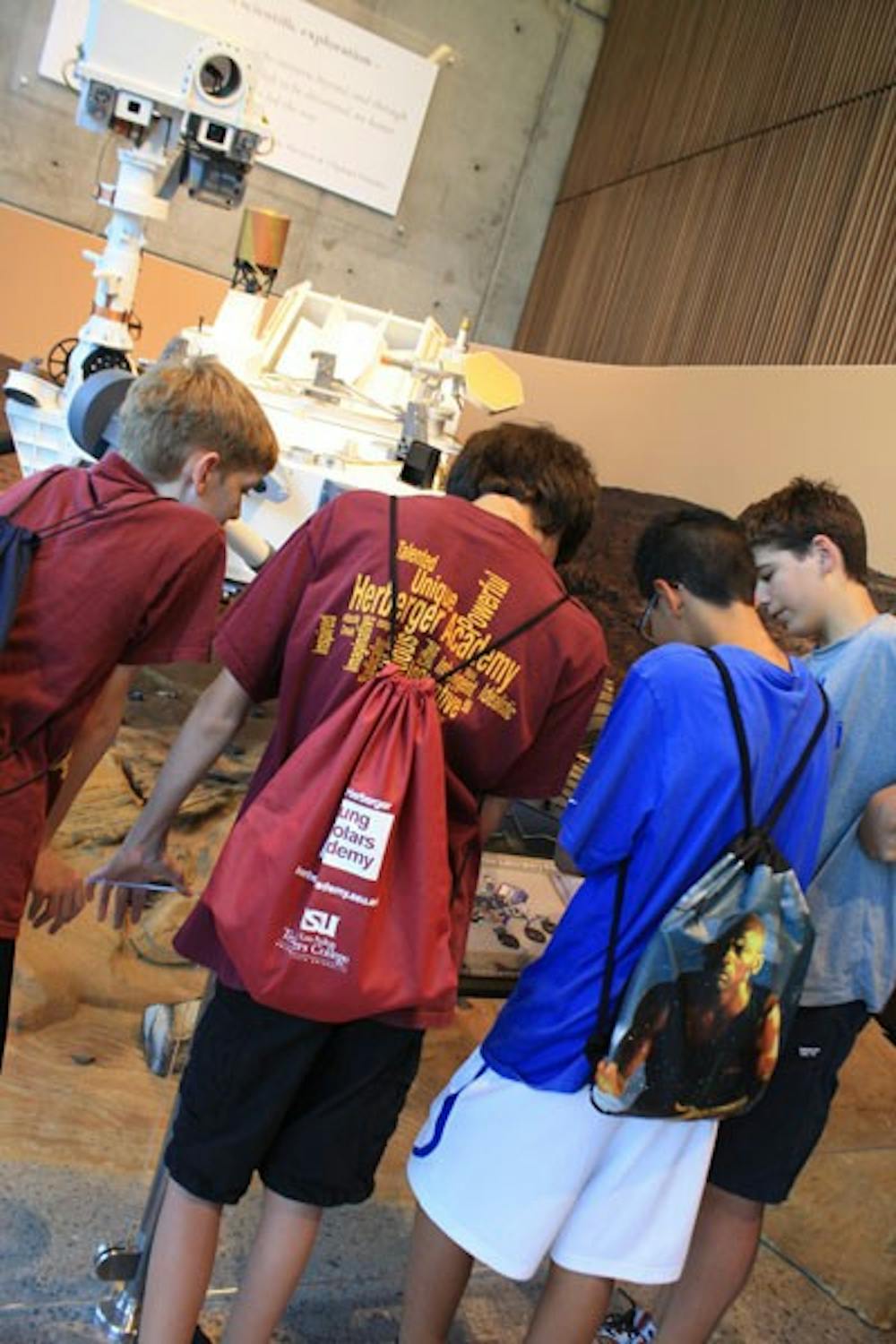 Young students from the West Campus's Herberger Institute visited the ISTB 4 building on its grand opening, beginning the tour by stopping at the life-size replica of the Mars Rover Curiosity. (Photo by Jessie Wardarski)