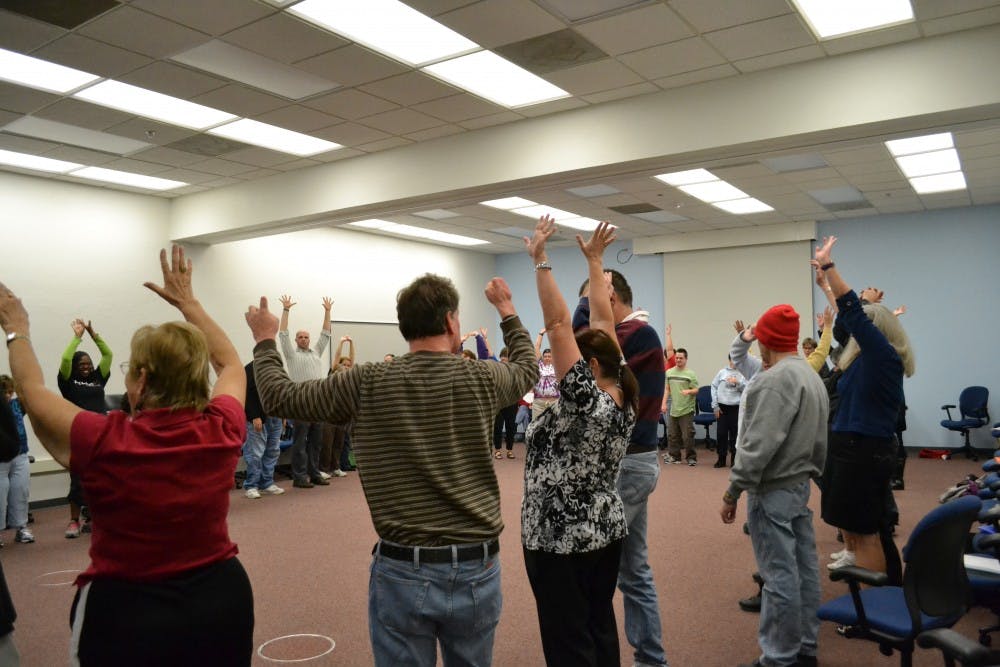 Detour actors, coaches and producers stretch in Opening Circle before rehearsal begins. Other activities, including back rubs and voice exercises, help warm up the actors and singers.
Photo by Mackenzie McCreary