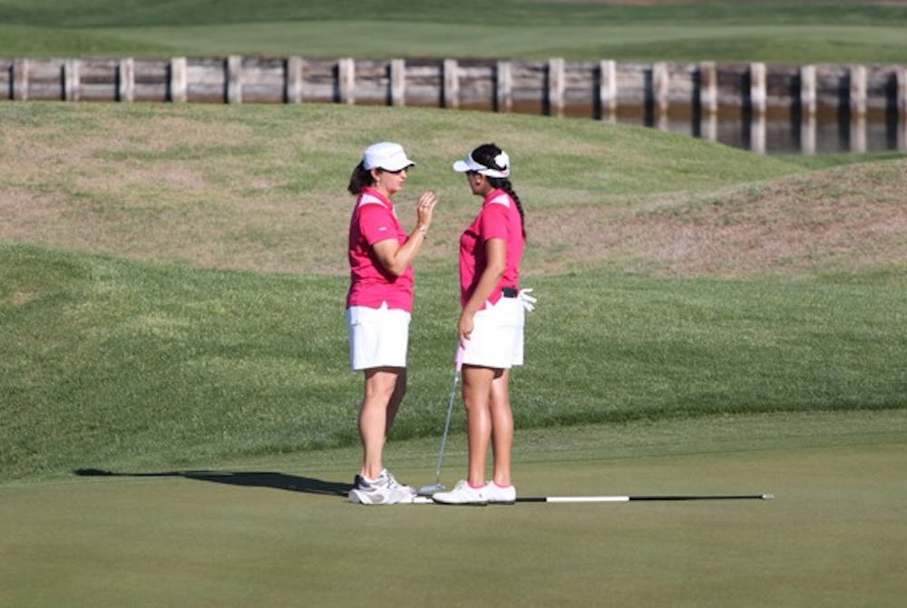 PASSING ON: ASU women’s golf coach Melissa Luellen gives tips to sophomore Laura Blanco during the Ping/ASU Invitation at Karsten Golf Club last April. The Sun Devils are currently competing in the Dale McNamara Invitational, which is named after Luellen’s mother. (Photo by Beth Easterbrook)