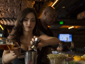 Bartender Bridget Davis 23 makes a drink for a customer at  Whiskey Row on April 7, 2016, on Mill Ave. in Tempe.