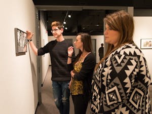 Photography majors Christian Bugarin (left), Robin Sendele (center), and photography and business marketing major Katie Keohan admire a piece of work titled ‘Birds’ by Julia Gonzalez. ASU held an opening reception for The Agency of Ideas at the Northlight Gallery on campus January 28th
