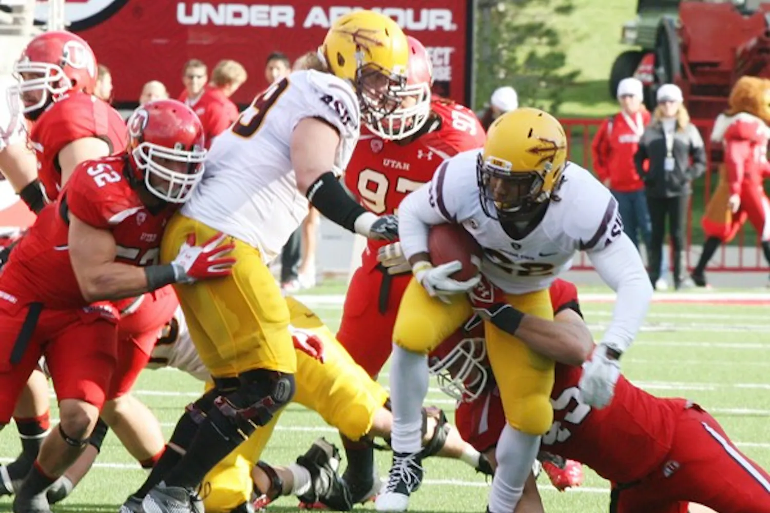 STILL STANDING: Junior running back Jamal Miles tries to break a tackle by Utah junior linebacker Boo Andersen during the fourth quarter of the Sun Devils’ 35-14 win over the Utes. The Sun Devils are undefeated in Pac-12 play thus far this season. (Photo by Tyler Emerick)