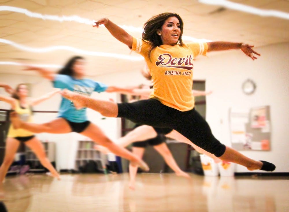 An airborne Ricigliano does center leaps across the floor. 