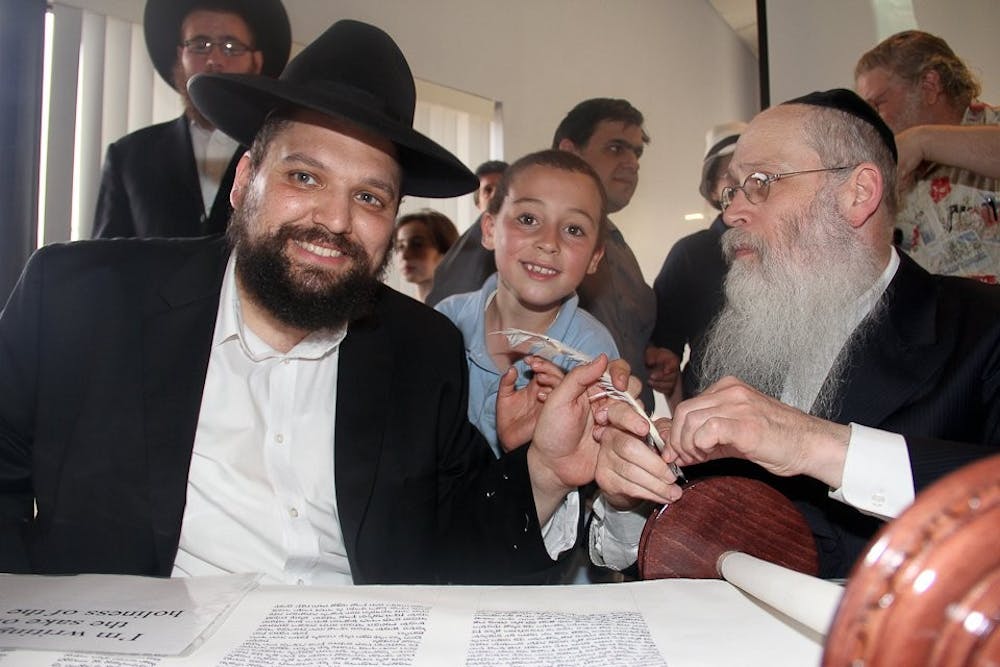  Rabbi Shmuel Tiechtel (on the left) leads Shabbat at the Rohr Chabad Center every Friday night. Photo courtesy of Matt Chesin