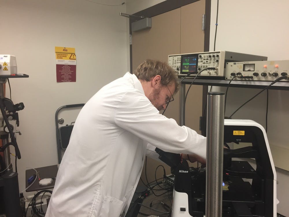 Research assistant Joshua Sadar&nbsp;works on a nanodevice that sequences DNA.