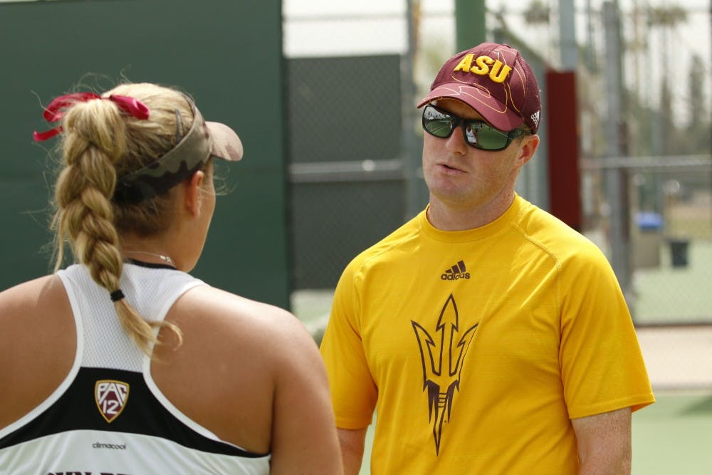 ASU women’s tennis assistant coach Matt Langley talks with a player during a match against UNLA at the Whiteman Tennis Center in Tempe, Arizona on Wednesday, March 22, 2017. 