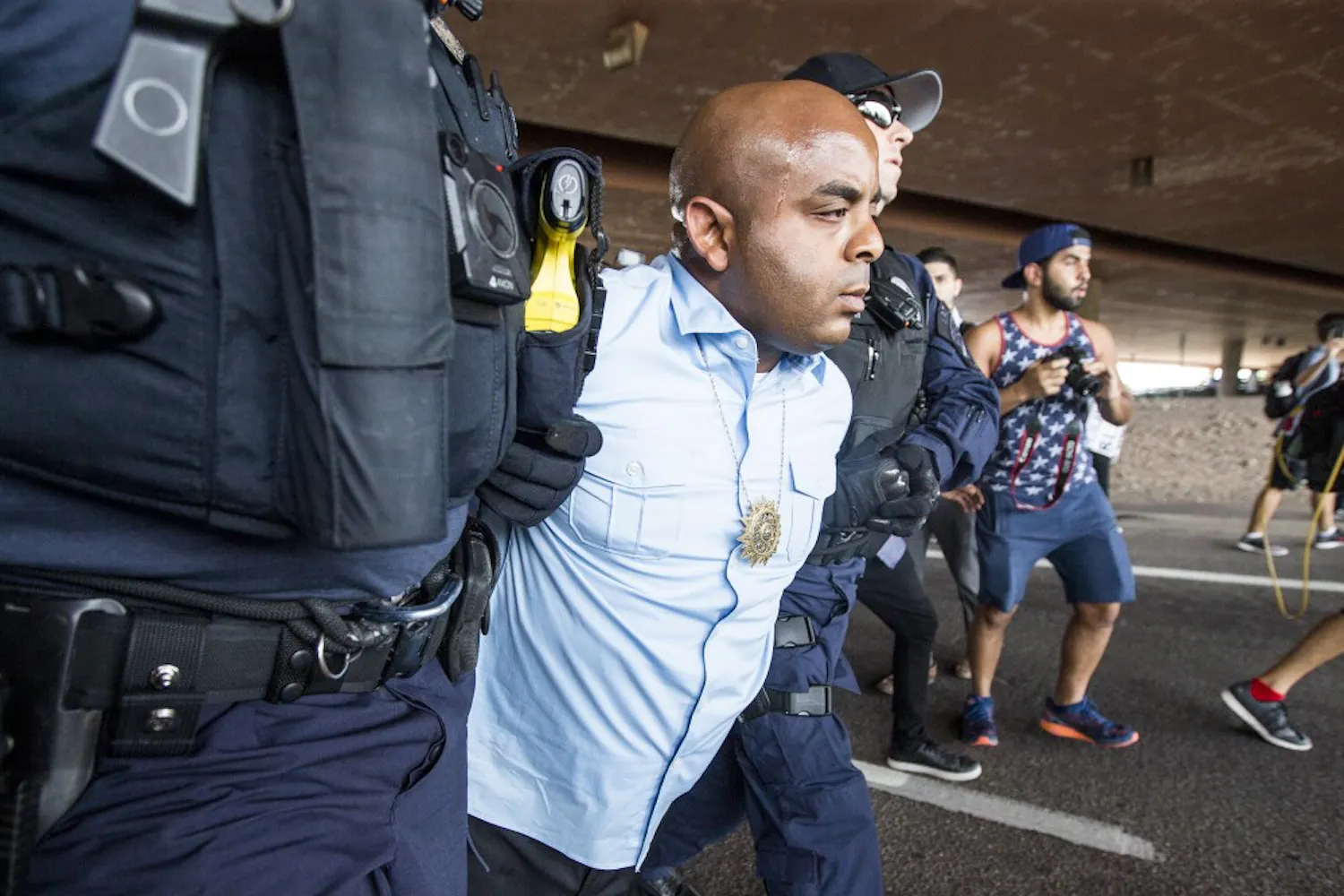 Rev. Jarrett Maupin is arrested during a police-violence protest on the Mill Avenue bridge on Monday, Sept. 26, 2016. Maupin was one of a few people arrested during the event.