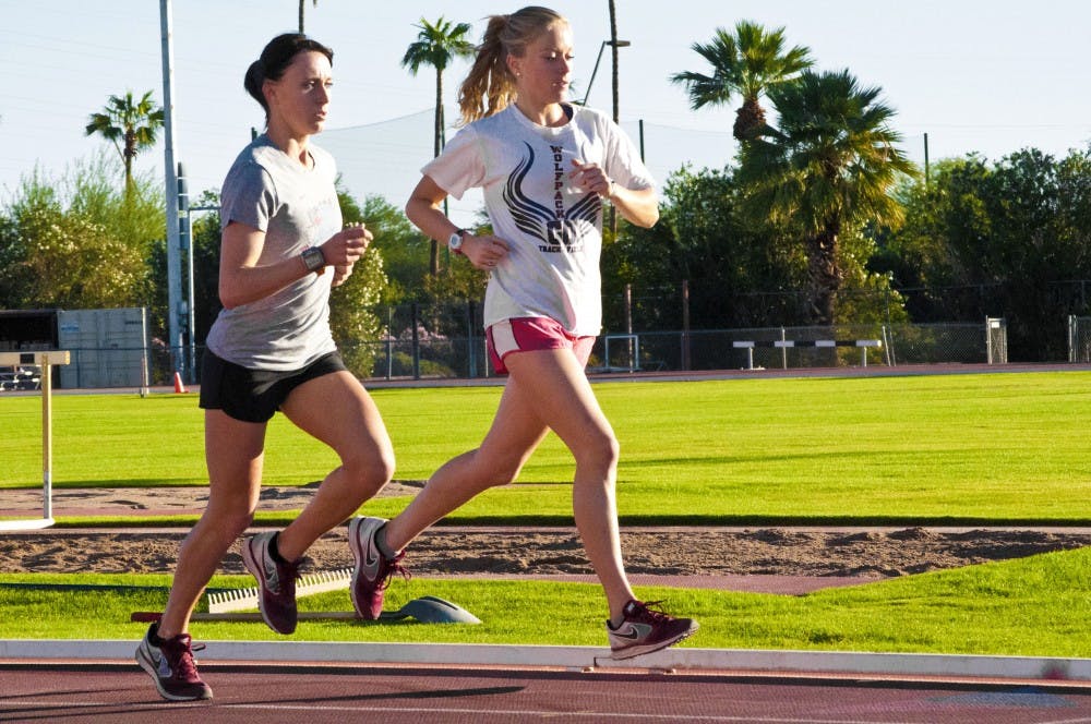 Junior Shelby Houlihan and freshman Miranda Kewley run sprints on the Joe Selleh Track. The cross country team is preparing for the West Regionals. (Photo by Katie Dunphy)