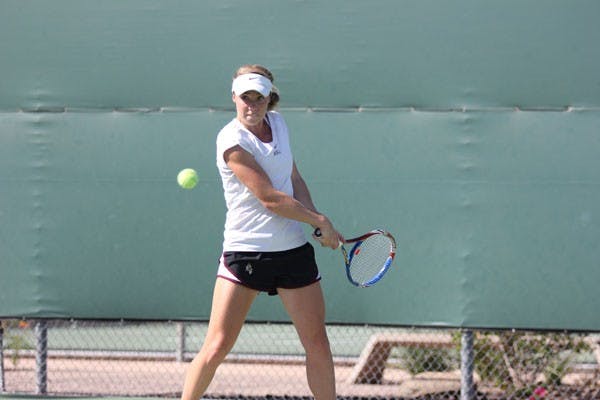 Senior Hannah James winds up for an underhand swing during a practice prior to the Wolverine Invitational last week. (Photo by Kyle Newman)