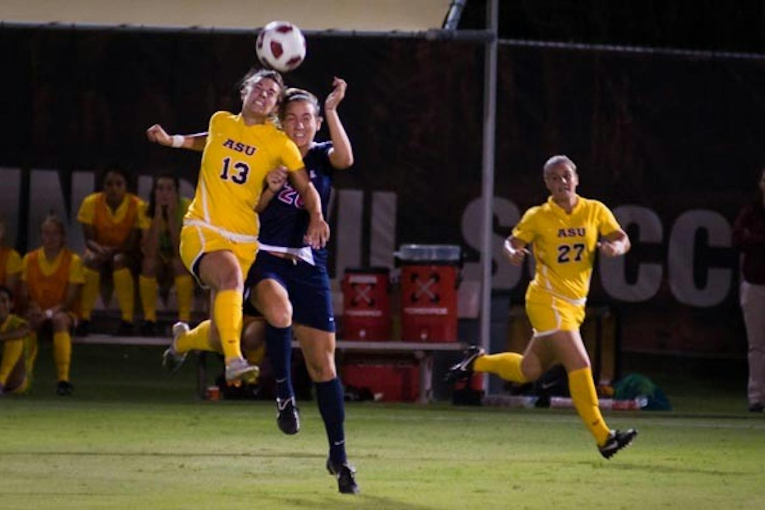 HEAD ON: Senior midfielder Alexandra Elston collides in mid air with a UA defender during ASU's 2-1 win Saturday. Elston scored both of ASU's goals en route to the rivalry win, notching the fourth two-game goal of her career. (Photo by Aaron Lavinsky)