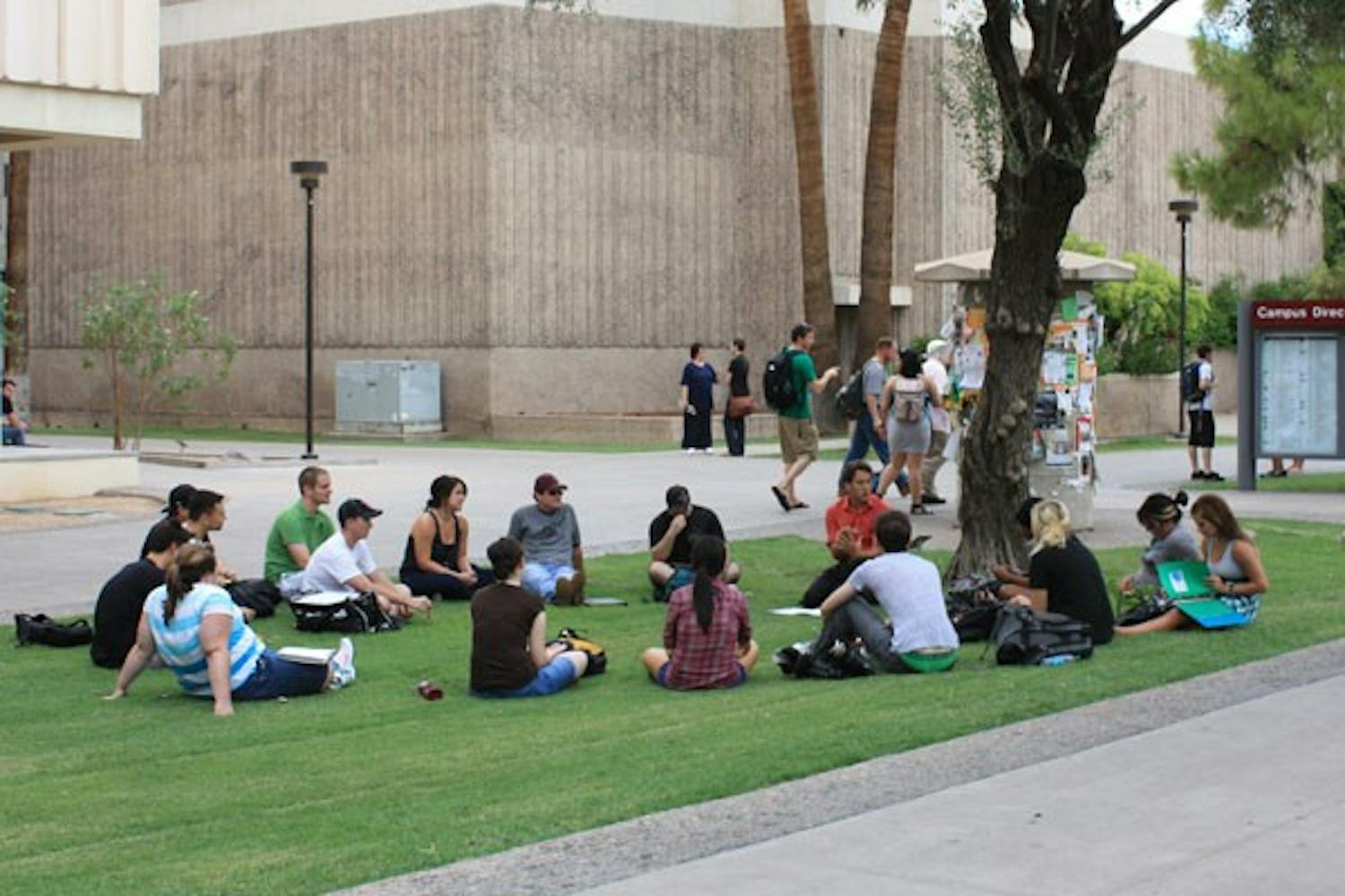 NEXT BEST THING: After being evacuated because of smoke from the Stauffer Communication Arts building on Thursday afternoon, one teacher decides to keep class going on the lawn right outside. (Photo by Jessica Weisel)