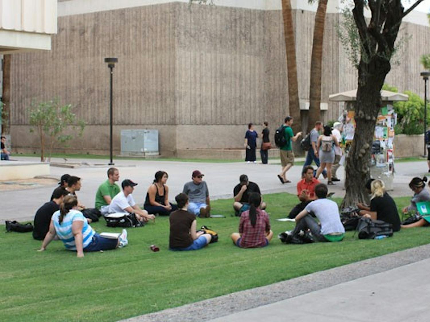NEXT BEST THING: After being evacuated because of smoke from the Stauffer Communication Arts building on Thursday afternoon, one teacher decides to keep class going on the lawn right outside. (Photo by Jessica Weisel)