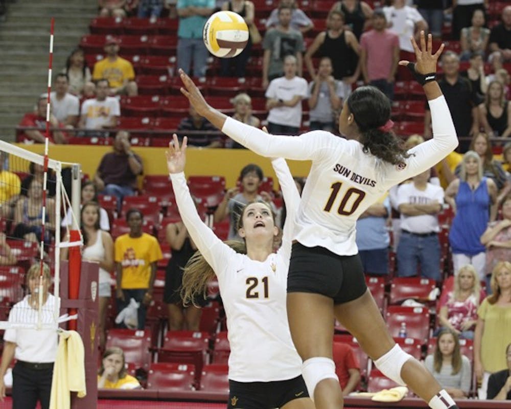 IT TAKES TWO: Sophomore setter Sarah McGaffin (21) lobs the ball for junior middle blocker Erica Wilson during the Sun Devils’ win over Denver on Friday. Wilson received tournament MVP honors for her performance over the weekend. (Photo courtesy of Steve Rodriguez)