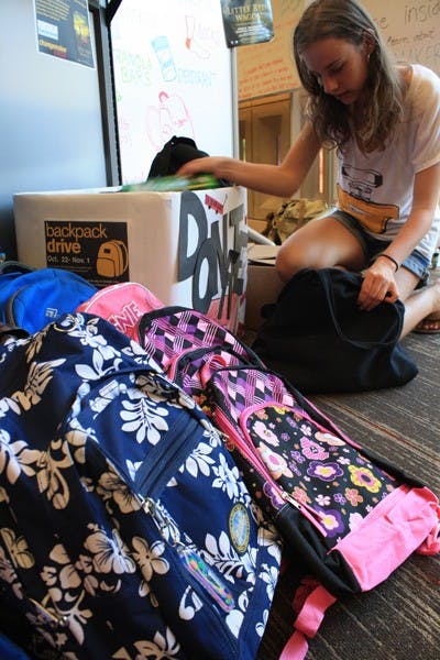 Biology sophomore Kristen Reynolds donates notebooks and other school supplies  to Changemaker Central’s backpack drive Thursday on the Tempe campus.  (Photo by Jessie Wardarski)