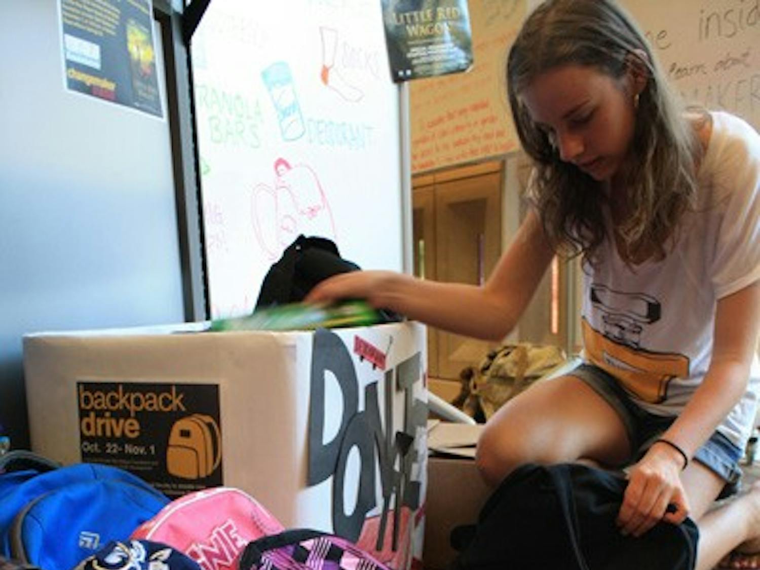 Biology sophomore Kristen Reynolds donates notebooks and other school supplies  to Changemaker Central’s backpack drive Thursday on the Tempe campus.  (Photo by Jessie Wardarski)