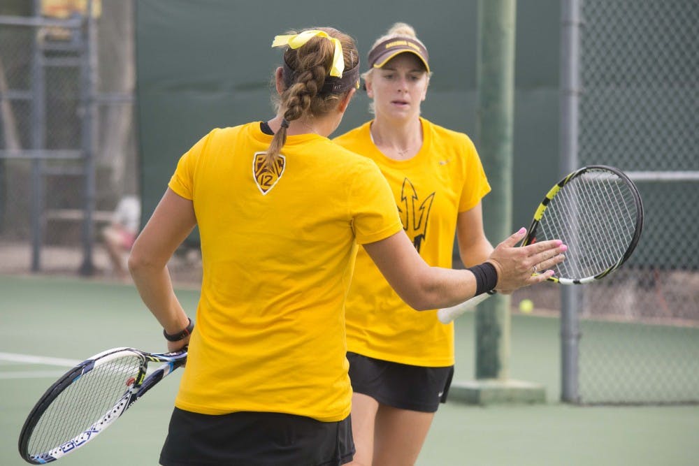 ASU doubles partners Kassidy Jump and Joanna Smith celebrate after a point. Jump and Smith played NAU's Hailey Rochin and Marta Lewandowska in an abandoned match. (Morgan Hipps/The State Press)