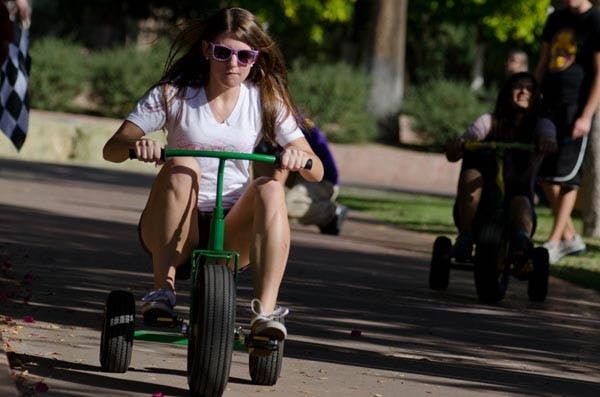 TRIKING FOR A CAUSE: Hannah Grivna, a junior communication and event planning major and member of Gamma Phi Beta Sorority, races for Trike-la-tron 2010, a Greek Life cancer fundraiser. (Photo by Aaron Lavinsky)