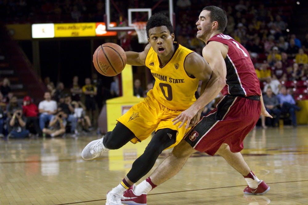 ASU junior guard Tra Holder (0) tries to drive by Cardinal guard Christian Sanders during a men's basketball game versus the University of Stanford Cardinal in Wells Fargo Arena in Tempe, Arizona on Saturday, Feb. 11, 2017. ASU won 75-69. (Josh Orcutt/State Press)