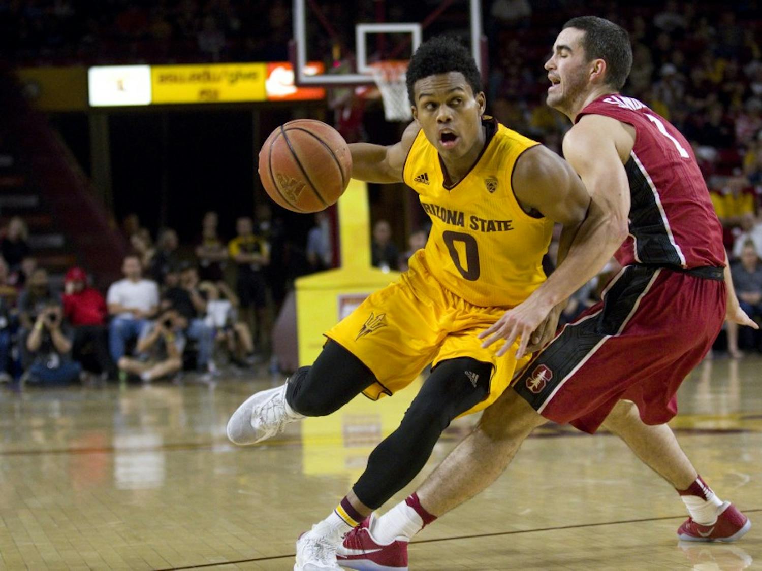 ASU junior guard Tra Holder (0) tries to drive by Cardinal guard Christian Sanders during a men's basketball game versus the University of Stanford Cardinal in Wells Fargo Arena in Tempe, Arizona on Saturday, Feb. 11, 2017. ASU won 75-69. (Josh Orcutt/State Press)