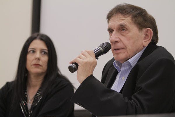 Though his story is a harrowing one, Bernard Scheer feels it is necessary for him to tell it to as many people possible. Here, the 87-year-old Holocaust survivor shares his experiences at the Osher Lifelong Learning Institute lecture while his daughter, Renay Leitman, looks on. (Photo by Sean Logan)