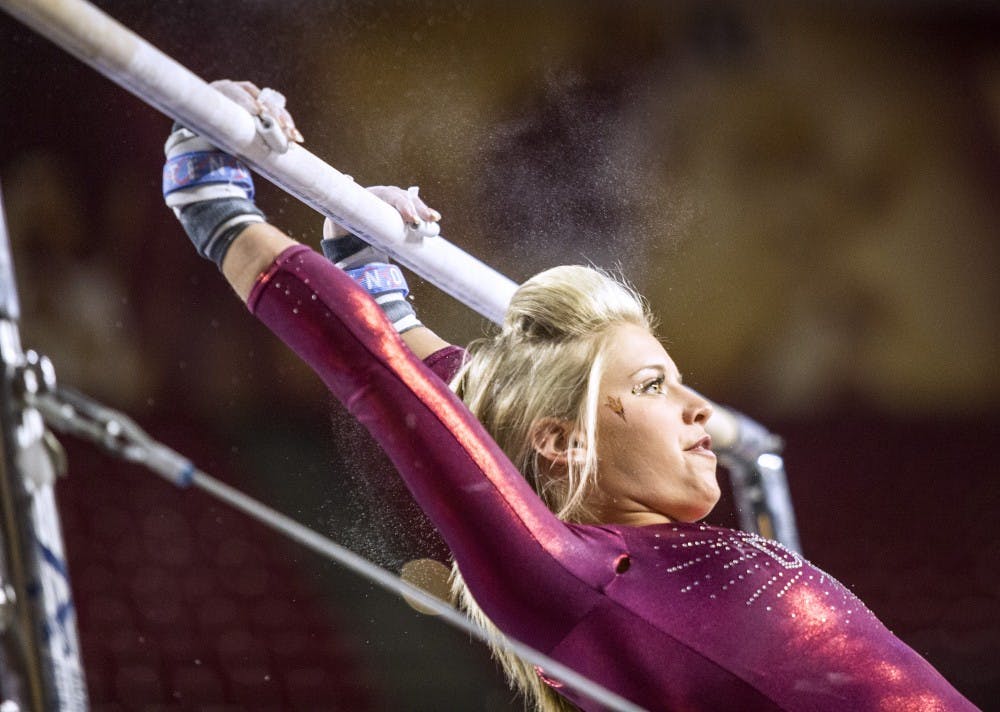 ASU senior Carissa Kraus performs on the bars during a gymnastics meet against the University of Washington Huskies at Wells Fargo Arena in Tempe, Ariz., on Monday, Jan. 18, 2015. The Huskies posted a 194.650-192.450 victory over the Sun Devils.