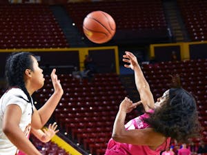 Arizona State University senior gaurd Elisha Davis shoots the ball as she falls backwards in a game against the University of Southern California held on Sunday, Feb. 7, 2016, at the Wells Fargo Arena in Tempe.  