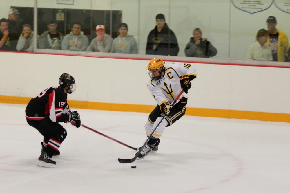 Colin Hekle, captain of the ASU hockey team, goes head to head with a member of the San Diego State team. The Sun Devils won 12-1. (Photo by Diana Lustig)
