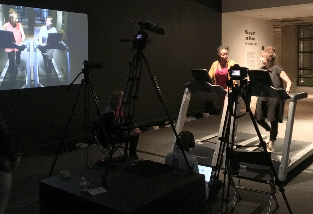 Liz Lerman and Kiki Jenkins walk on treadmills to begin their conversation as they are recorded by ASU students at the ASU Art Museum&nbsp;on Jan. 19, 2017.