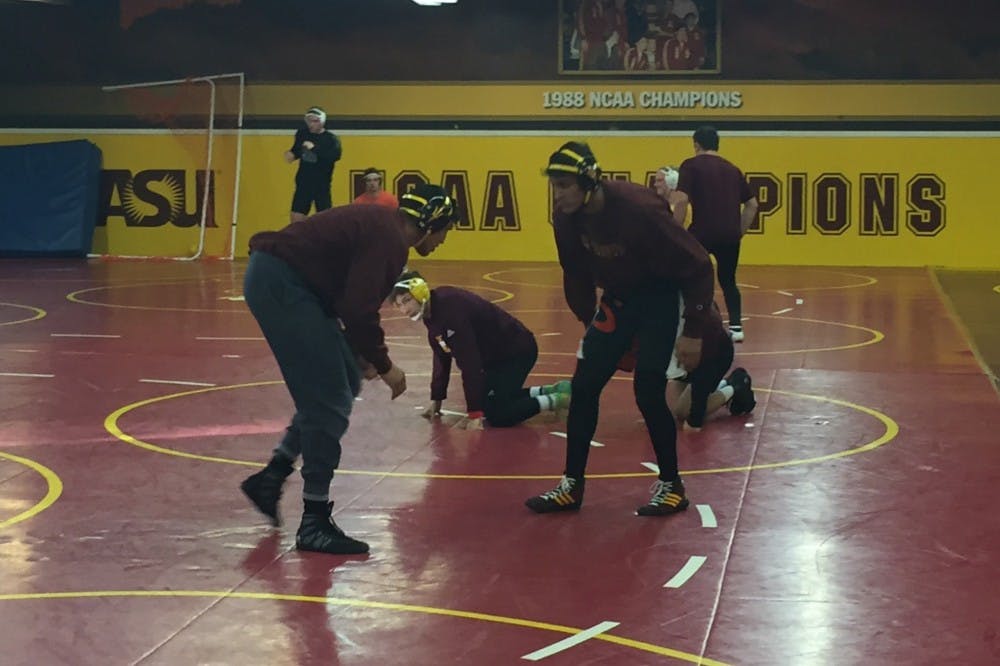 Zahid and Anthony Valencia prepare to wrestle during practice on Tuesday Nov. 15, 2016,&nbsp;at the Riches Wrestling Complex in Tempe, Arizona.