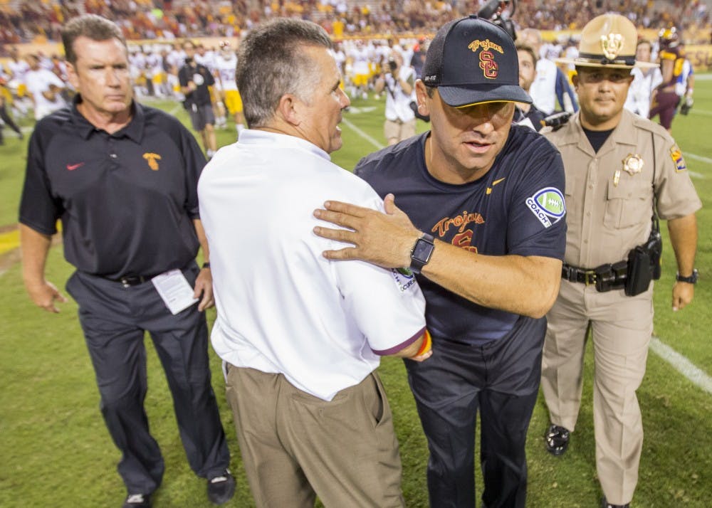 ASU head coach Todd Graham, left, and USC coach Steve Sarkisian shake hands after a contest on Saturday, Sept. 26, 2015, at Sun Devil Stadium in Tempe. The ASU football squad lost to the visiting USC Trojans 42-14.