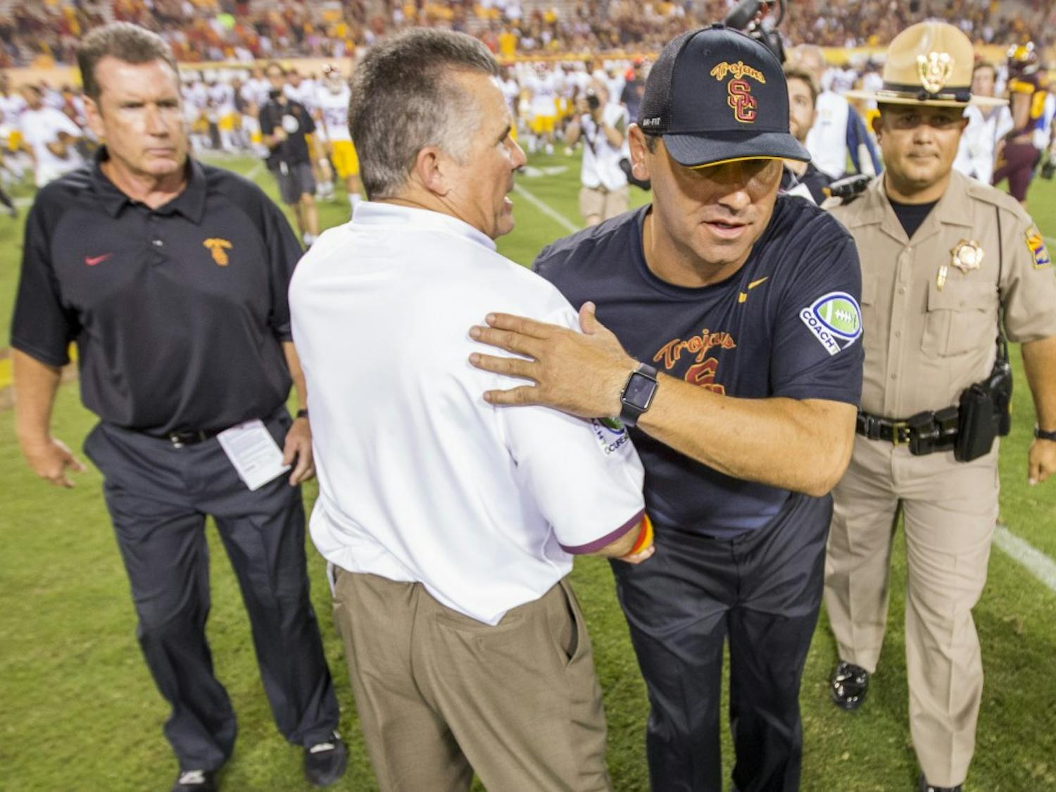 ASU head coach Todd Graham, left, and USC coach Steve Sarkisian shake hands after a contest on Saturday, Sept. 26, 2015, at Sun Devil Stadium in Tempe. The ASU football squad lost to the visiting USC Trojans 42-14.
