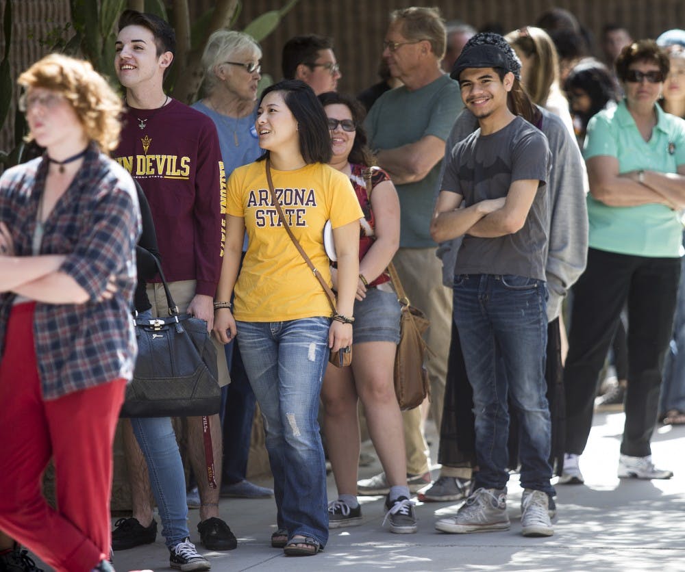 ASU freshmen Andrew Villalobos, in maroon, and Danielle Forbes, in gold, wait in line for a rally for presidential candidate Bernie Sanders at the Phoenix Convention Center in Downtown Phoenix on Tuesday, March 15, 2016. 