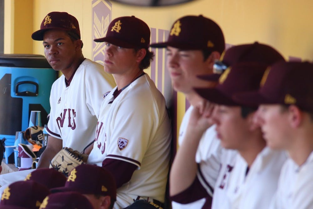 Freshman outfielder Tyler Williams (25), far left, looks on with the rest of the ASU baseball team as head coach Tracy Smith speaks to the team after the Maroon & Gold scrimmage at Phoenix Municipal Stadium on Saturday, Feb. 13, 2016.
