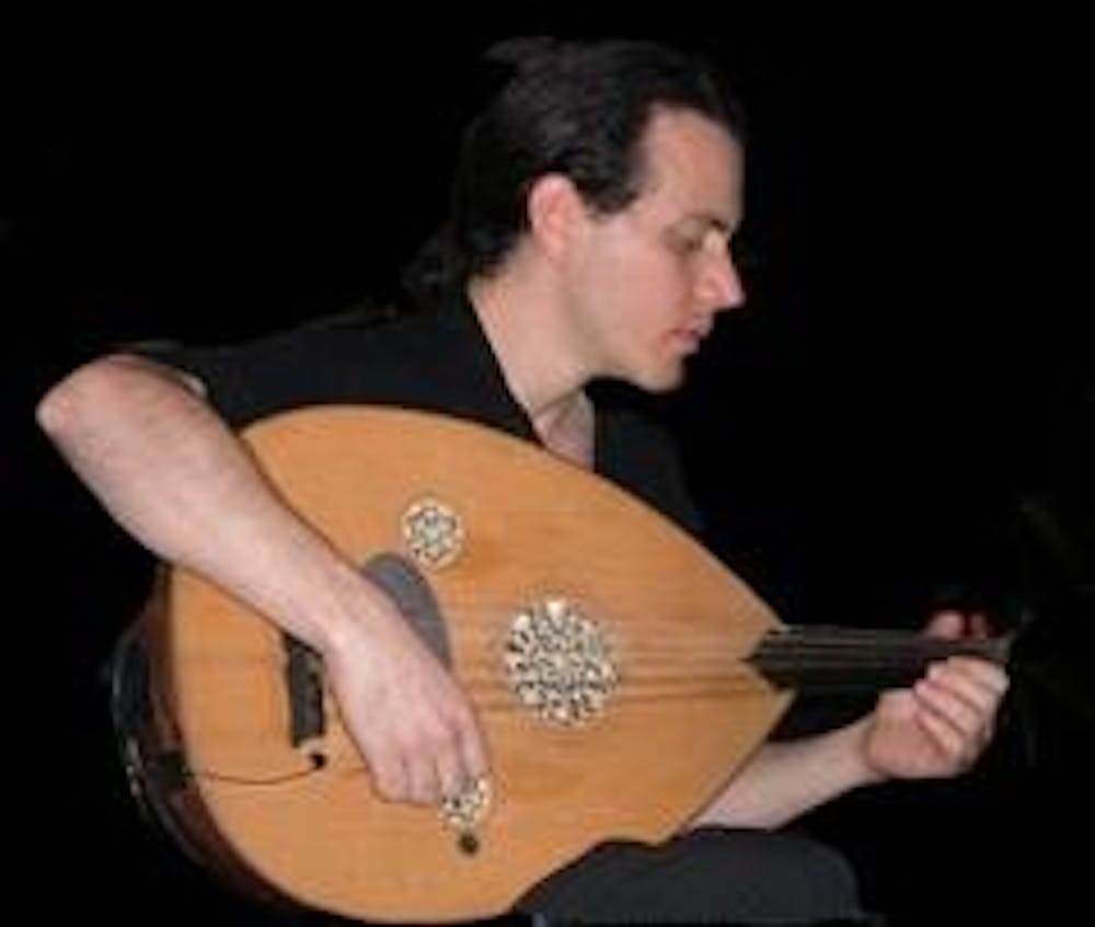 Bandmate Eric Zang plays the oud. Photo courtesy of Cosmos. 