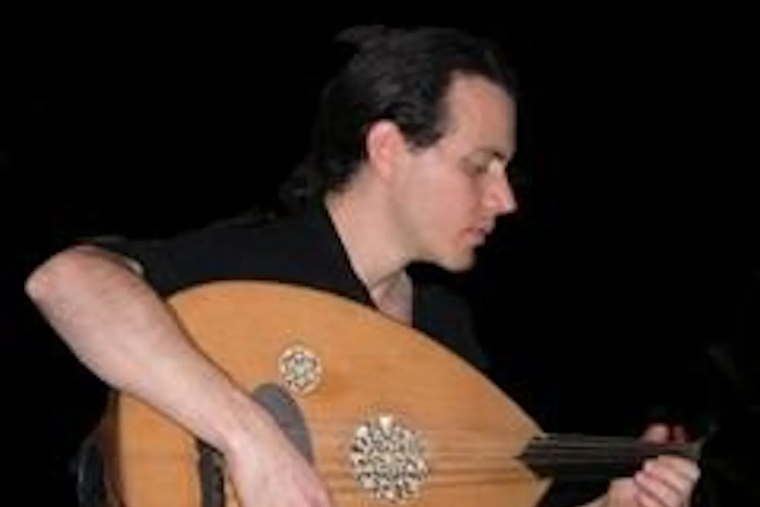 Bandmate Eric Zang plays the oud. Photo courtesy of Cosmos.