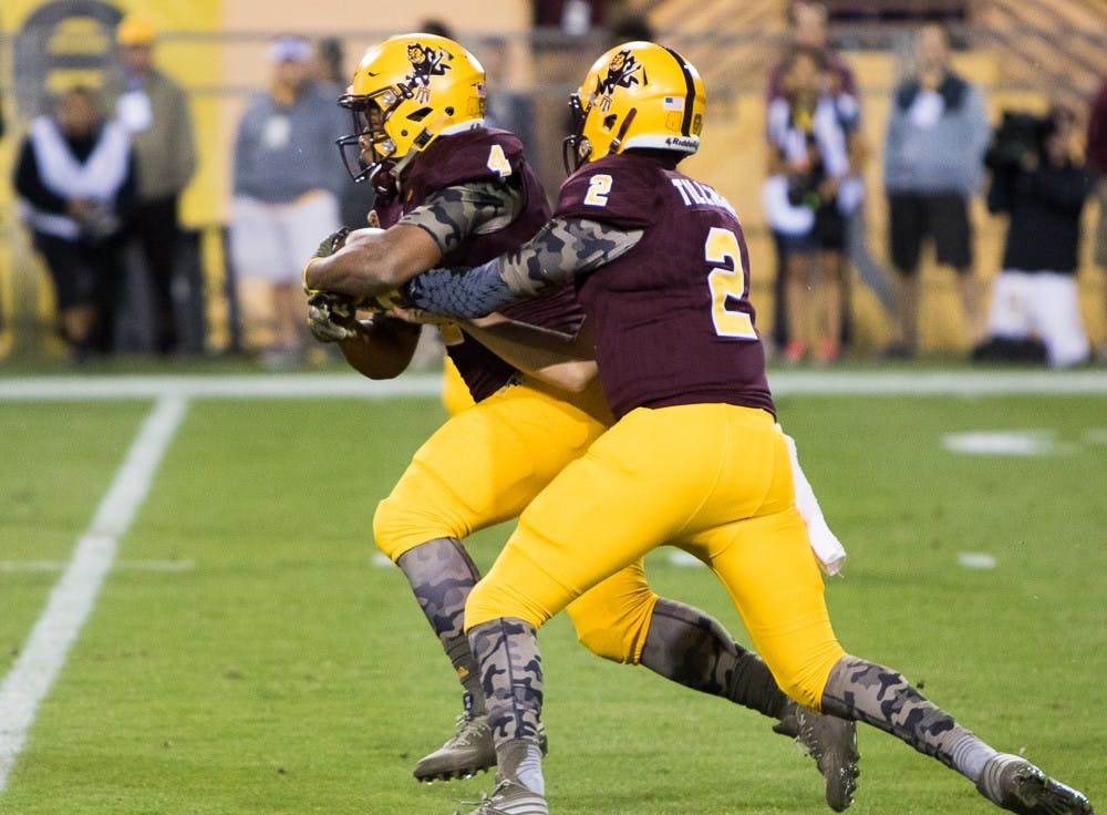 Redshirt senior quarter back Mike Bercovici (2) hands the ball off to sophomore running back Demario Richard (4) against Oregon on Thursday, Oct. 29, 2015, at Sun Devil Stadium in Tempe.