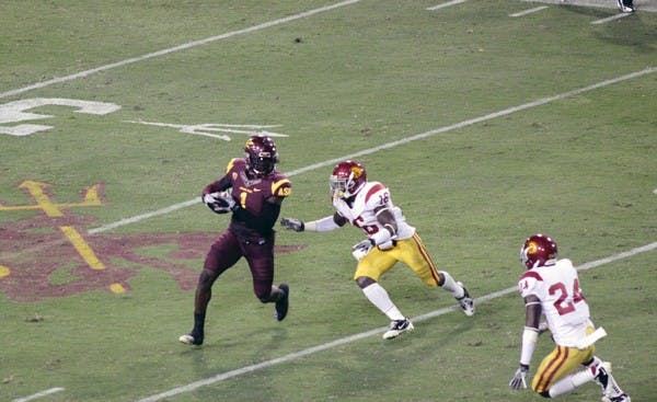 GOING THE DISTANCE: ASU senior wide receiver Mike Willie (1) attempts to run around USC redshirt cornerback Anthony Brown during the Sun Devils’ 43-22 win over the Trojans on Sept. 24. Willie’s ability to play the wide out position and his ability to block has played a crucial part in the Sun Devil offense. (Photo by Beth Easterbrook)