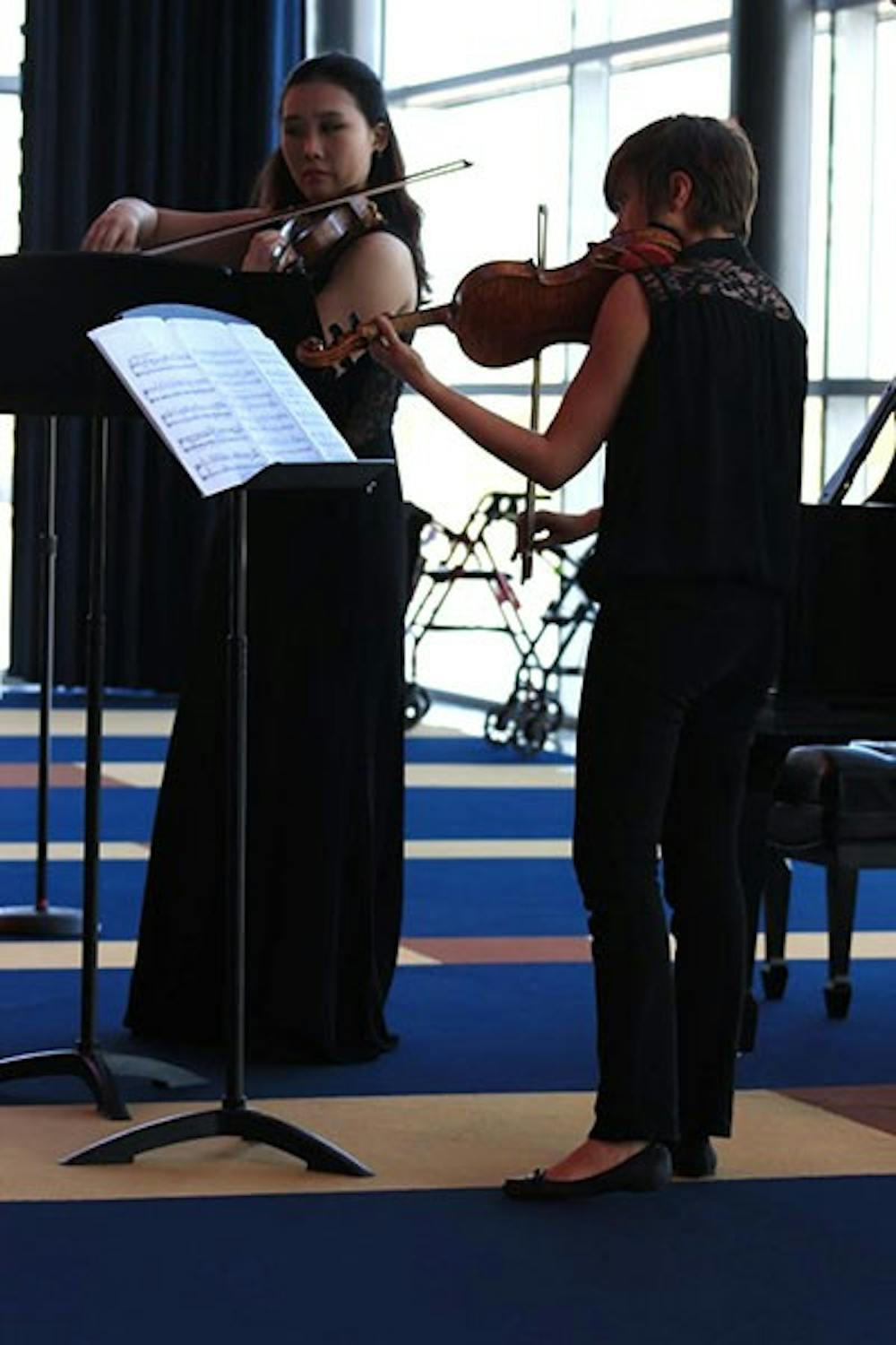 Violin performance sophomores Xiangyuan Huang and Clarice Collins perform at the Tempe Center for the Arts. The two violinists performed Prokofiev’s Sonata for Two Violins. (Photo by Micaela Rodriguez)