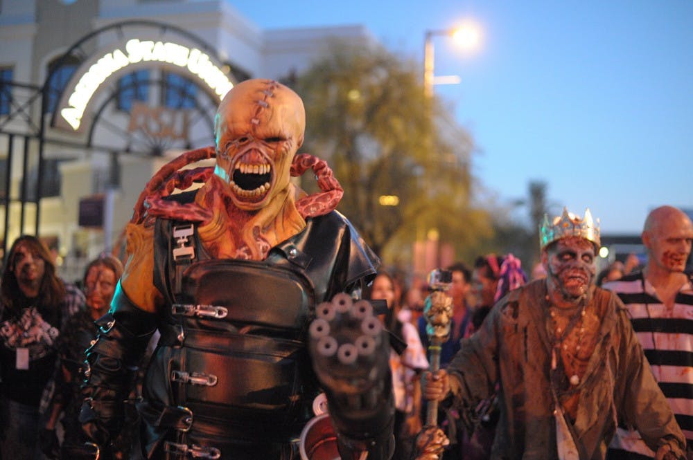 Zombies take part in the sixth annual Zombie Walk, Saturday, Oct. 25, 2014 in Phoenix. The event partners with St. Mary's Food Bank to bring donations for the city's homeless population. (Photo by Ben Moffat)