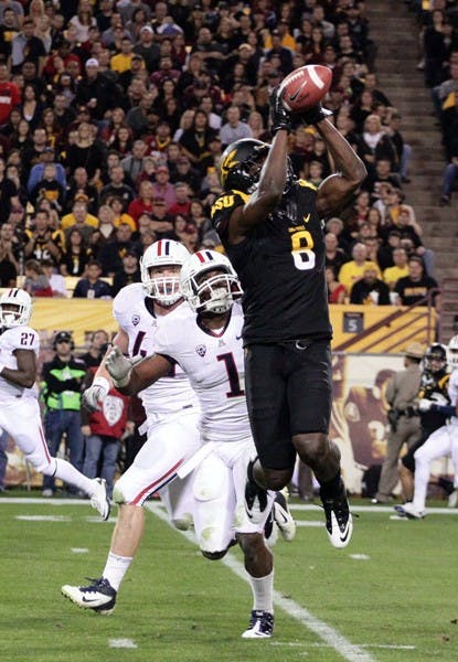 ASU senior wide receiver Gerell Robinson pulls down a pass from junior quarterback Brock Osweiler during the Sun Devils’ loss to UA on Saturday. Robinson racked up 199 yards receiving in the loss, a career high. (Photo by Beth Easterbrook)