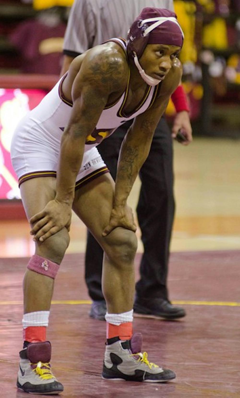 Ultimate Fighter: ASU senior and NCAA National Champion Bubba Jenkins stands on the mat after a victory over Cal State Fullerton on Nov. 27. Jenkins plans to coach at ASU after graduating, and then pursuing a career in MMA. (Photo by Aaron Lavinsky)