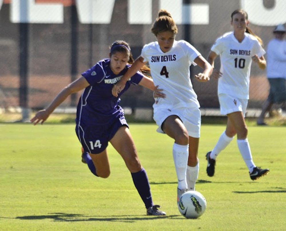 Junior forward Devin Marshall keeps the ball away from a Washington defender in a game against the Huskies last season. The Sun Devils earned their first win against NAU on Friday, shutting out the Lumberjacks 4-0. (Photo by Aaron Lavinsky)
